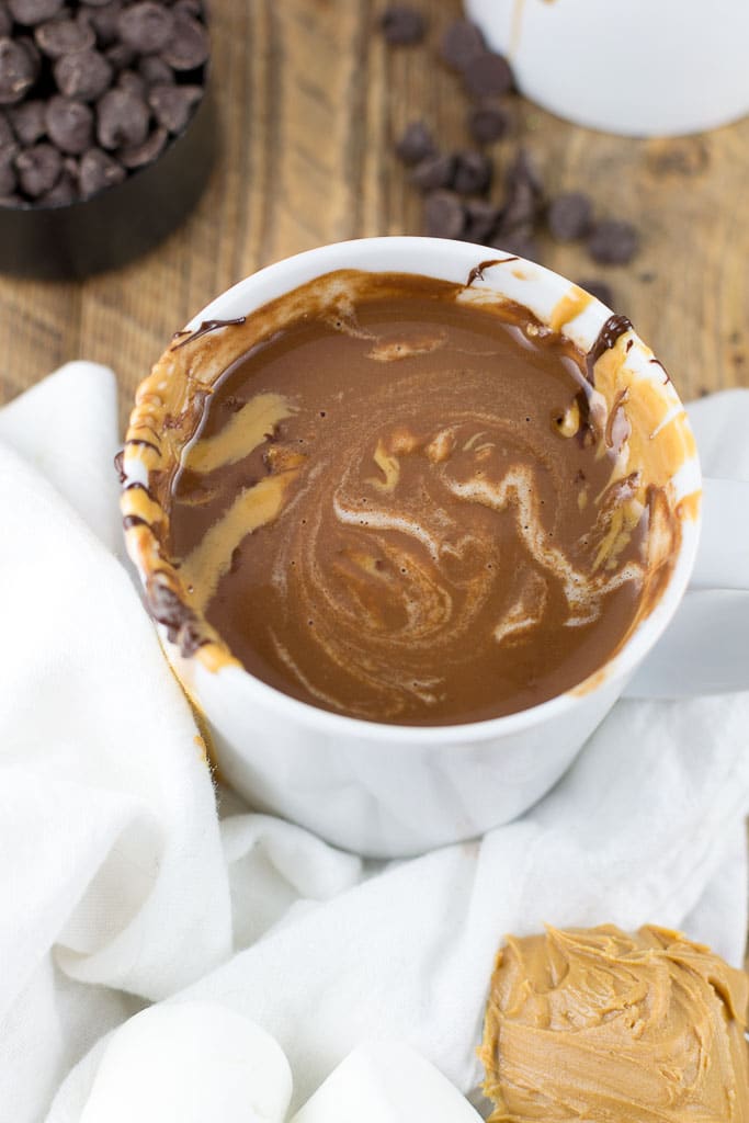 This vegan peanut butter hot chocolate is so creamy you won't believe it's gluten-free, dairy-free and vegan! It's made with only a few simple ingredients that I bet you already have them in your house. There is nothing better on a cold, winter day than whipping up this delicious peanut butter hot chocolate. It comes together in less than 10 minutes, too! I love topping it with more melted peanut butter, chocolate and some marshmallows for an extra little treat. With this recipe, you will never want to make hot chocolate from the packet again! #glutenfree #dairyfree #vegan