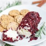 A goat cheese log with dried cranberries and cinnamon.