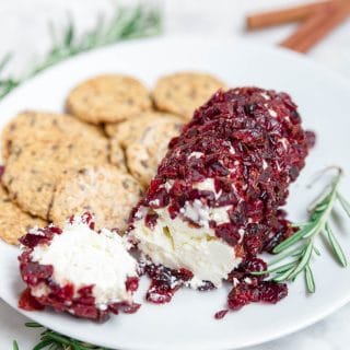 A goat cheese log with dried cranberries and cinnamon.