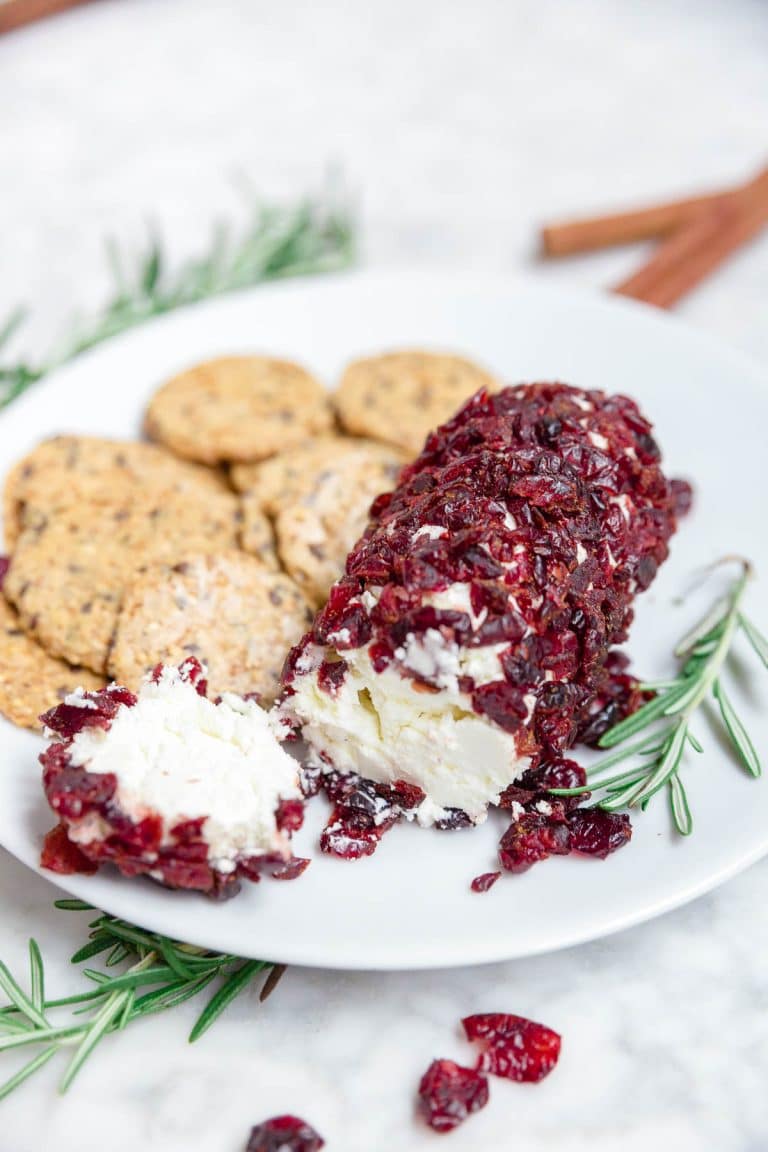 A goat cheese log with dried cranberries and cinnamon.