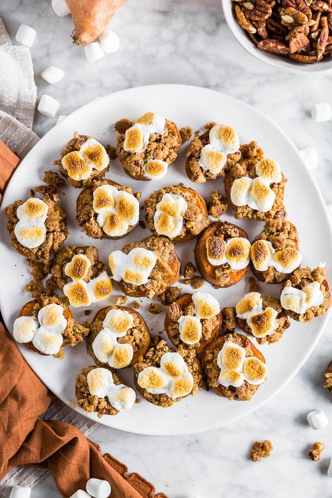 A white plate with sweet potato casserole bites with a brown sugar pecan crumble and toasted mini marshmallows