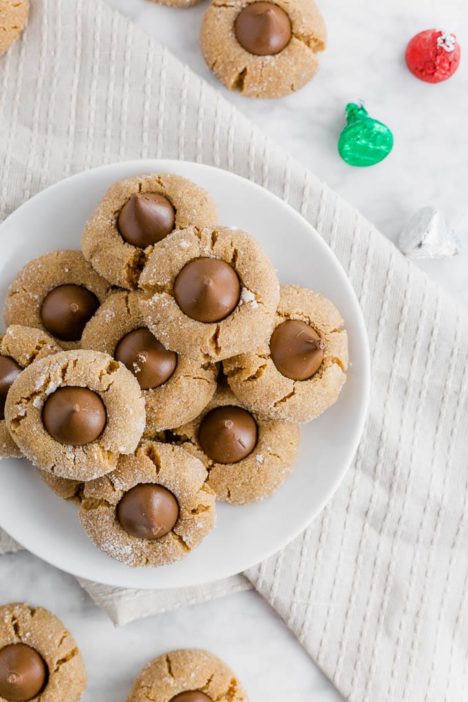 a plate of flourless peanut butter blossoms with chocolate kisses