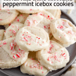 A plate of peppermint icebox cookies covered in white chocolate and topped with crushed candy canes.