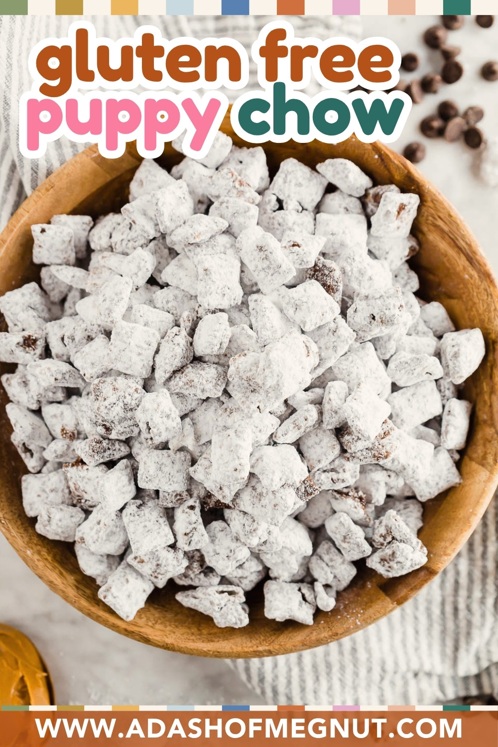 A wooden bowl filled with gluten-free, dairy-free puppy chow coated in powdered sugar sits on a table. The text reads "gluten free puppy chow," and the website “www.adashofmegnut.com” is displayed at the bottom.