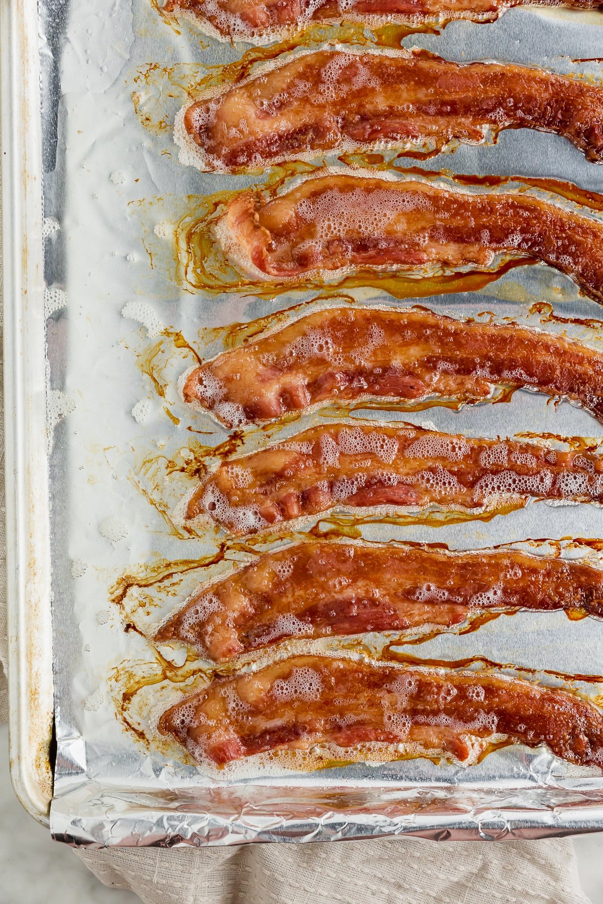 A baking sheet with cooked bacon straight fro the oven. 