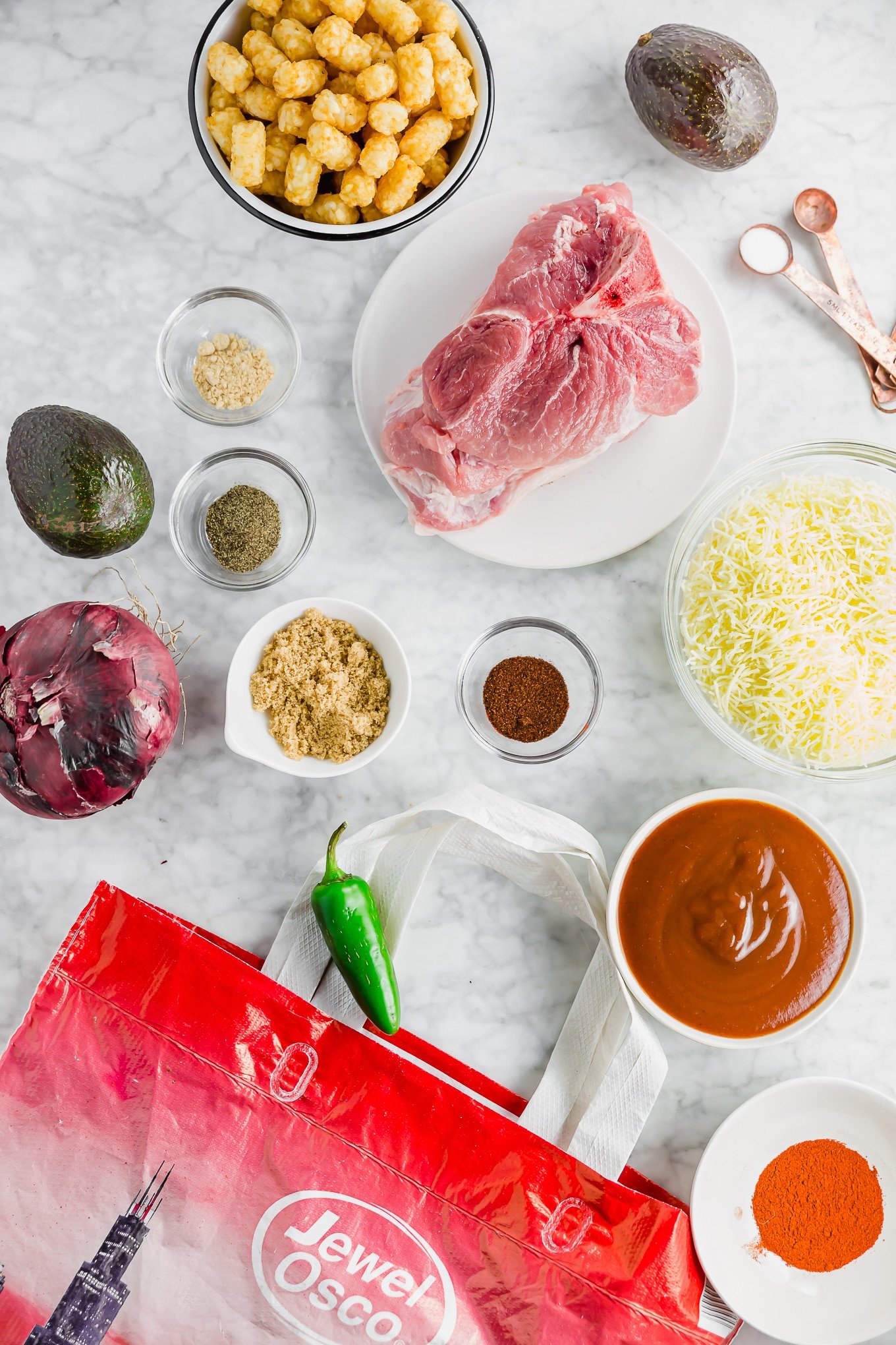 A photo showing ingredients to make BBQ Pulled Pork in the Instant Pot including brown sugar, pork shoulder, spices, BBQ sauce, and garlic.