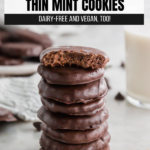 A photo of a stack of homemade thin mint cookies with the top cookie bitten in half.