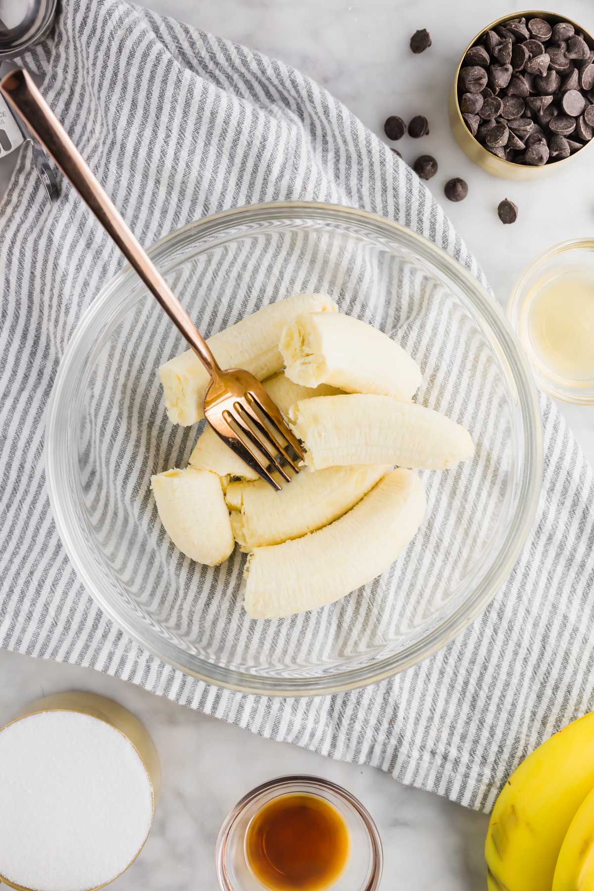 A bowl with ripe bananas ready for mashing for banana muffins.