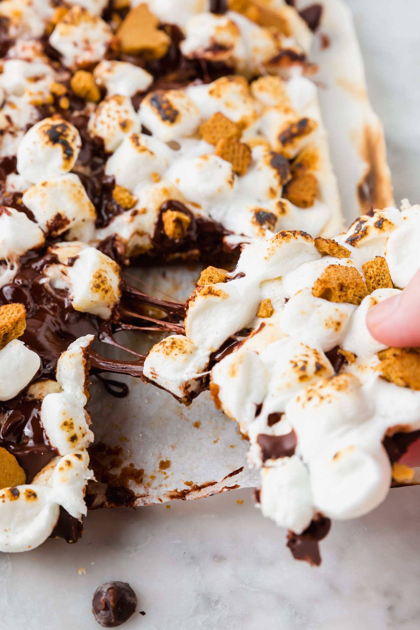 A slice of gluten-free s'mores bar being pulled out from the group.