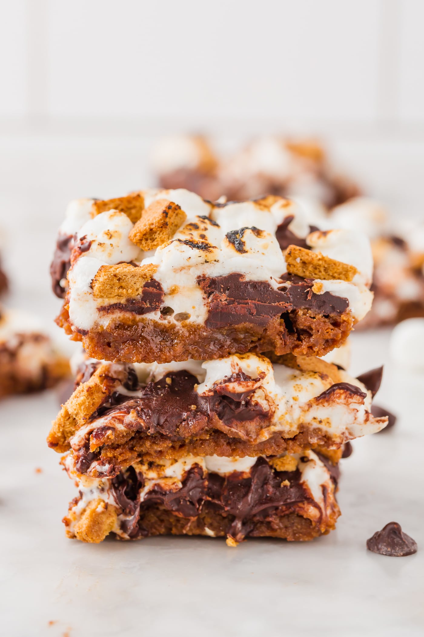 A stack of three s'mores bars on a marble table. 