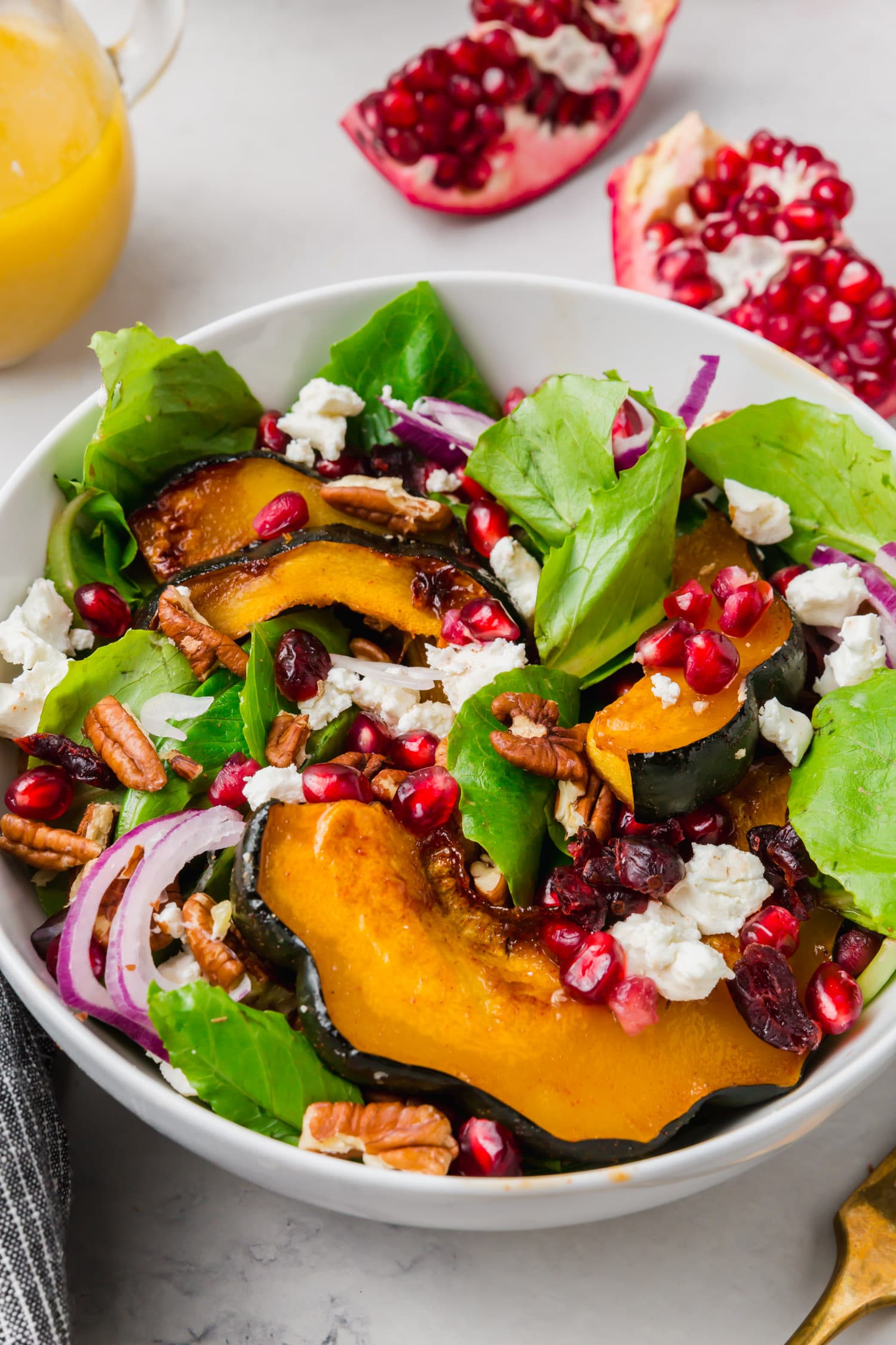 An acorn squash salad with pomegranate, red onion, goat cheese and pomegranate aril. 