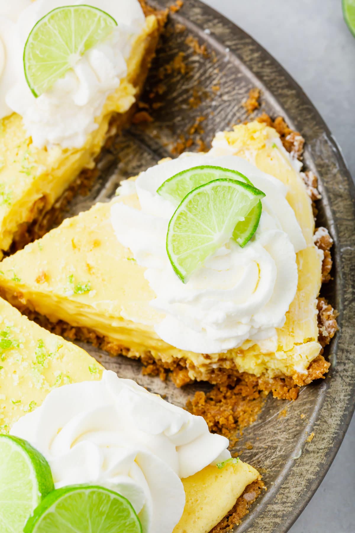 A photo of slices of key lime pie in a pie tin. 