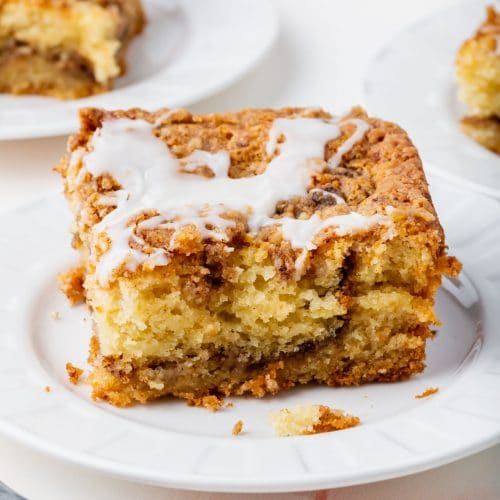 A slice of gluten-free cinnamon coffee cake on a small plate.