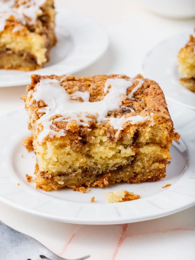 A slice of gluten-free cinnamon coffee cake on a small plate.
