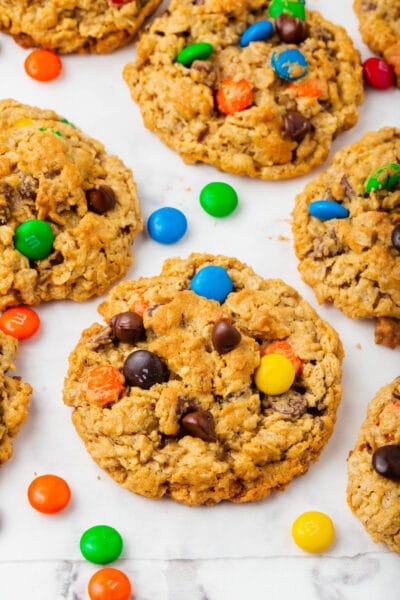 A tray of monster cookies with M&M candies sprinkled about.