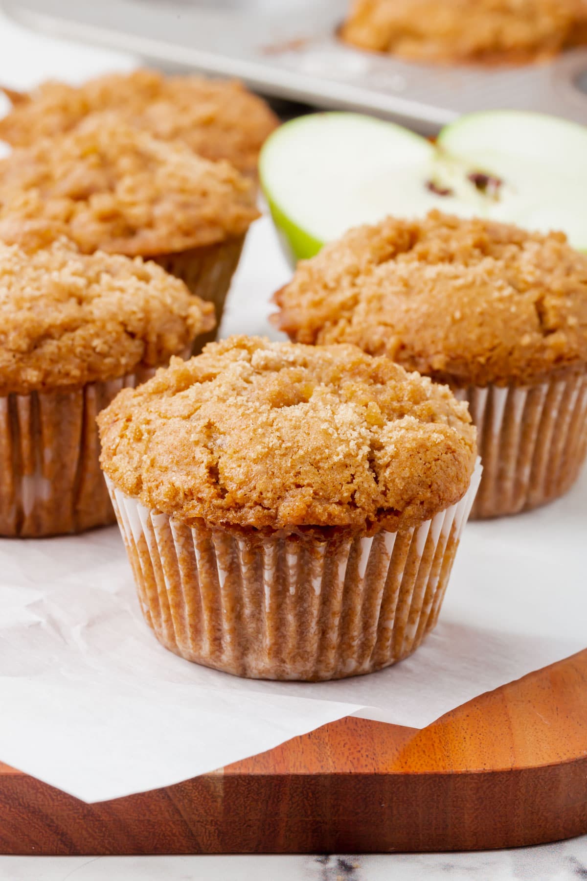 Four gluten-free vegan apple cinnamon muffins.