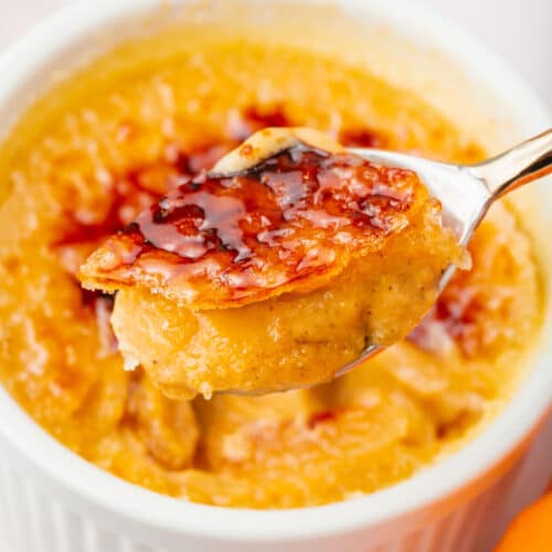 A spoonful of pumpkin crème brûlée with a creamy filling and crackle crust topping.