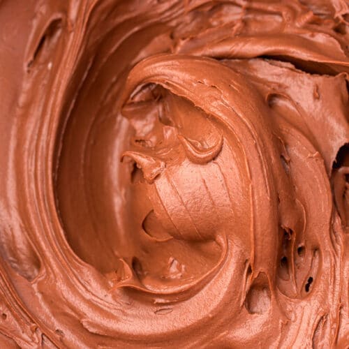 A close-up shot of chocolate cream cheese frosting.