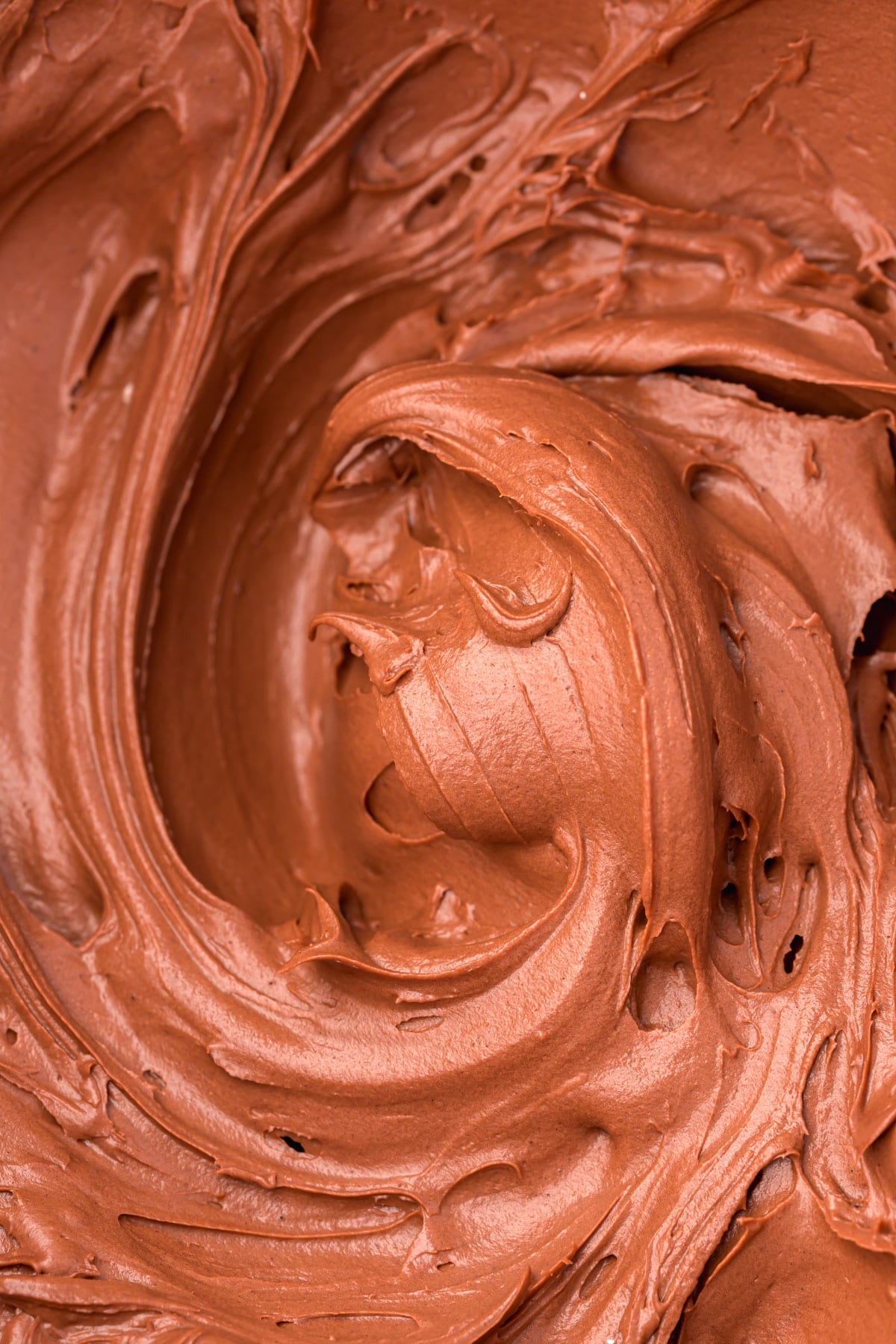 A close-up shot of chocolate cream cheese frosting.