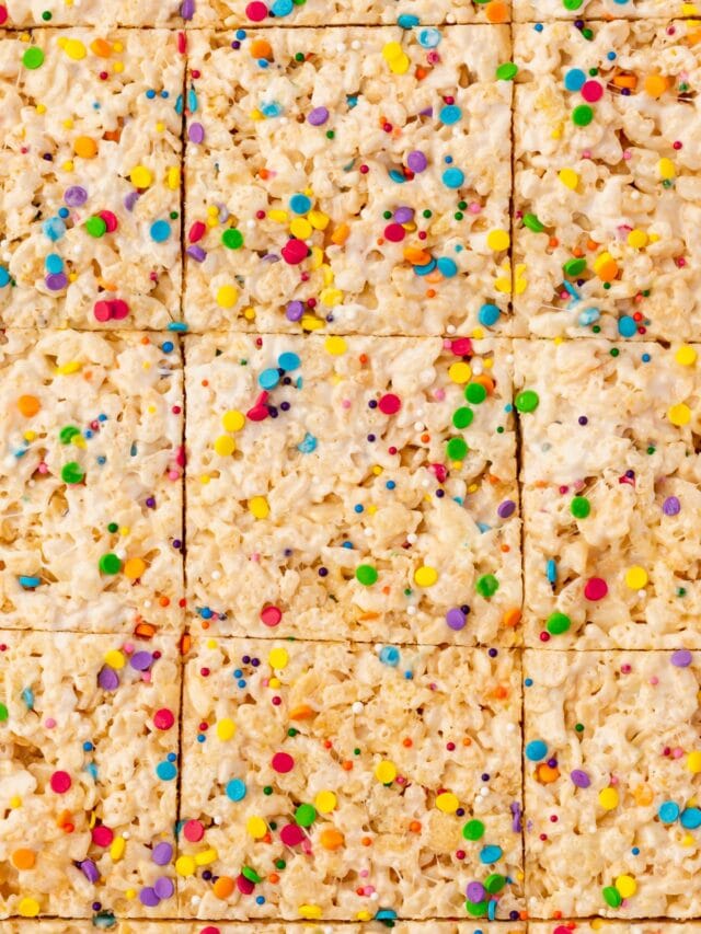 A tray of gluten-free rice krispies treats topped with colorful sprinkles.