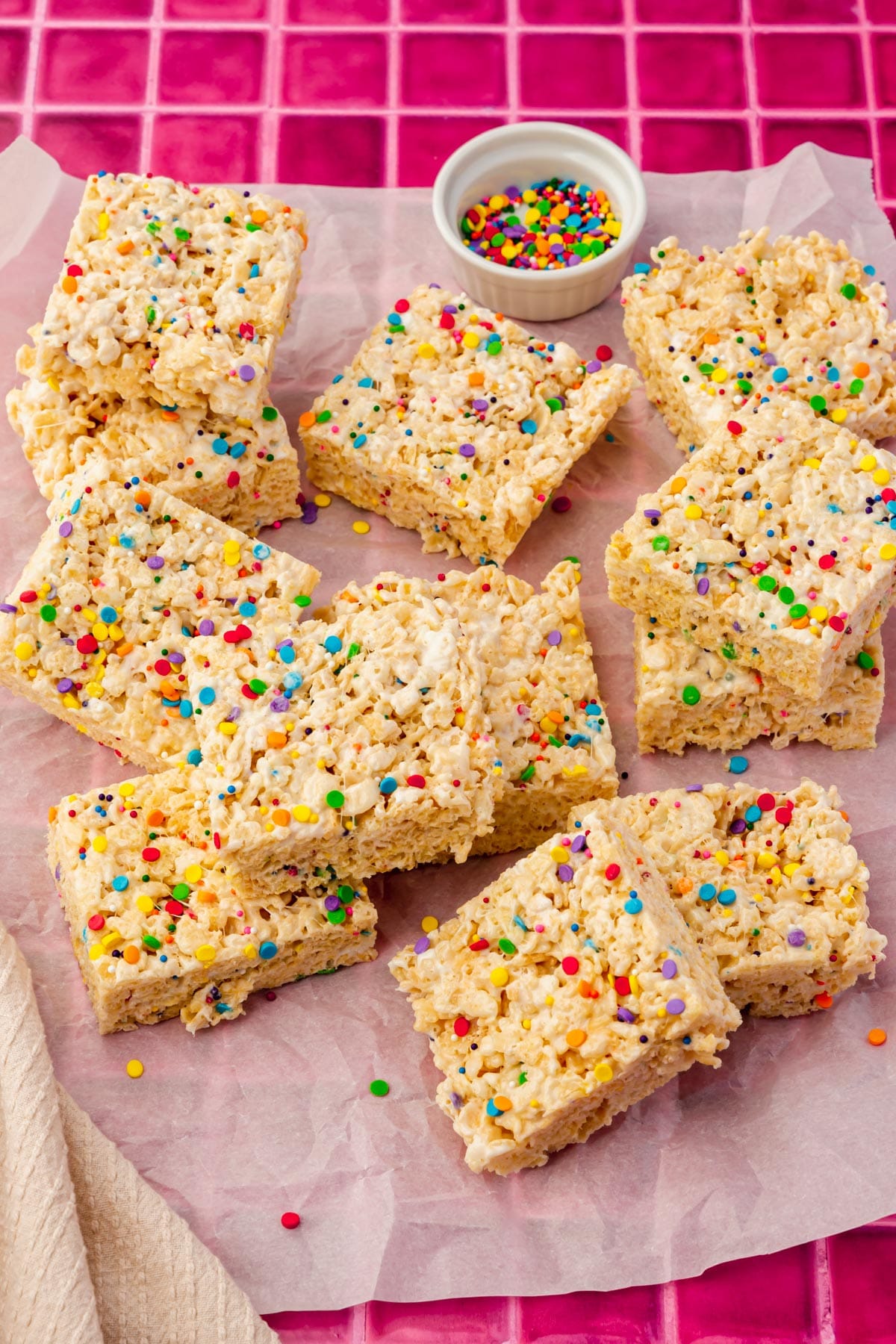 A tray of gluten-free rice krispies treats topped with colorful sprinkles.