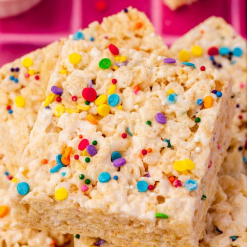 A pile of gluten-free rice krispies treats topped with colorful sprinkles.