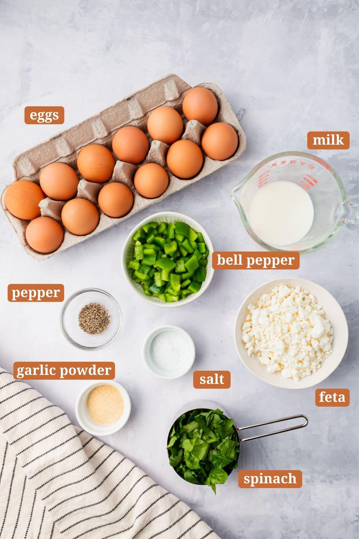 The ingredients needed for making spinach feta egg muffins.