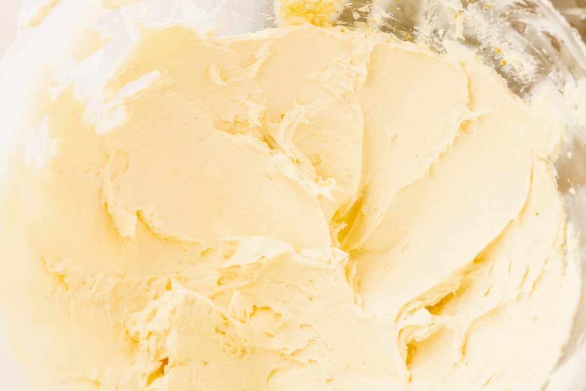 A mixing bowl with creamed butter in it.
