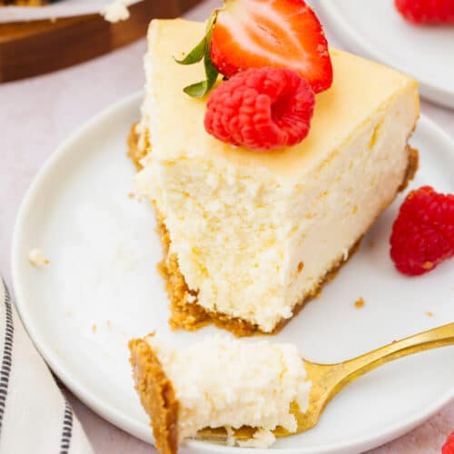 A slice of gluten-free cheesecake topped with red berries.