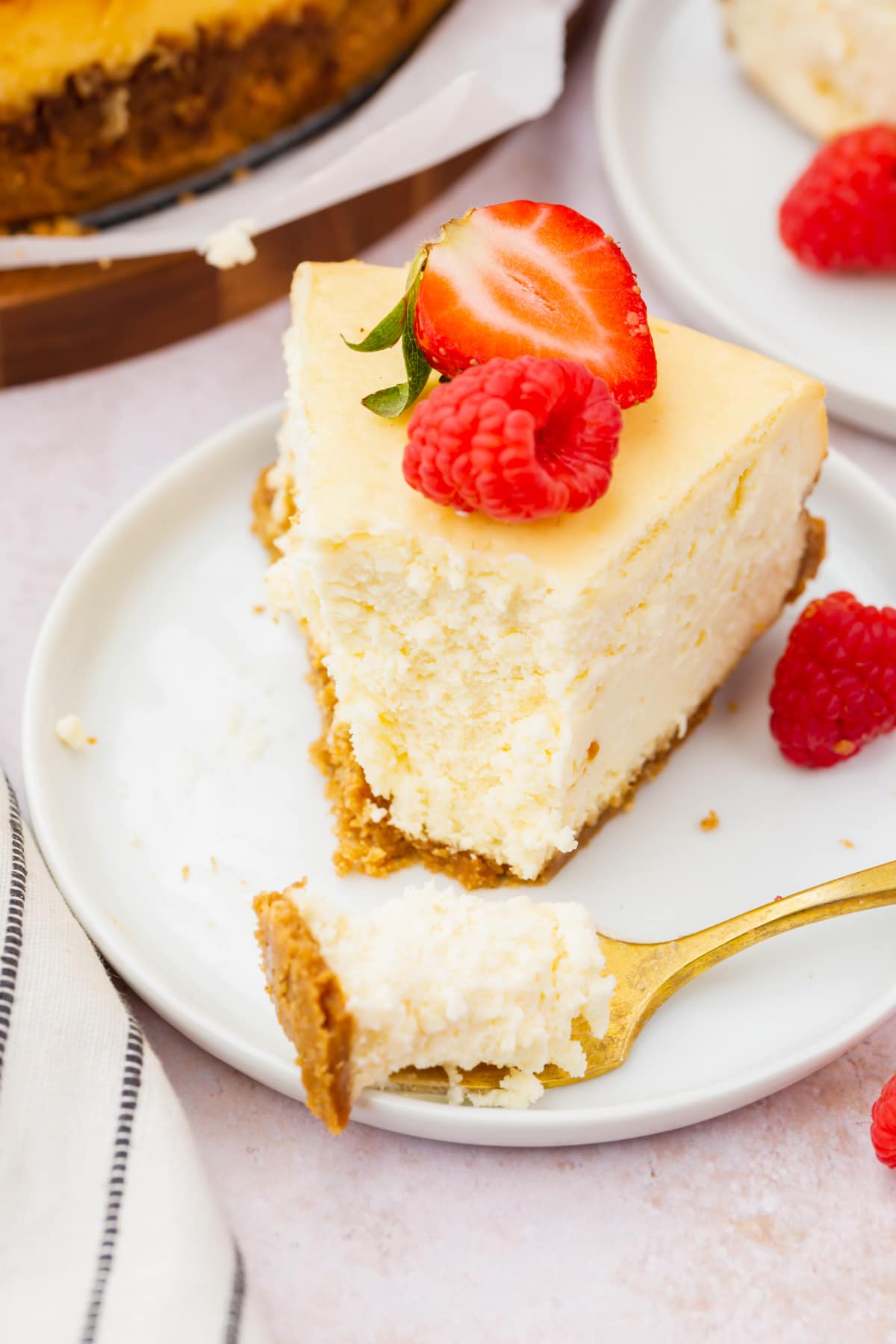 A slice of gluten-free cheesecake topped with red berries.
