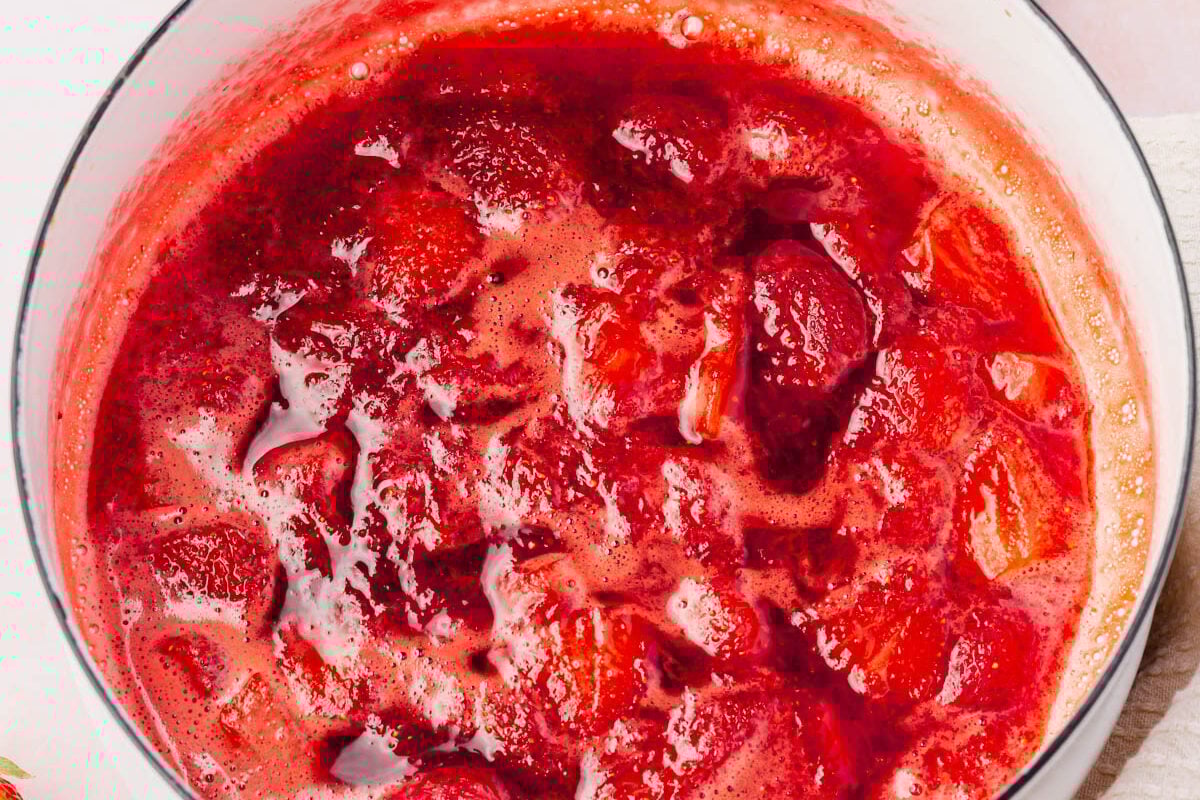 A sauce pan containing a chunky strawberry coulis.