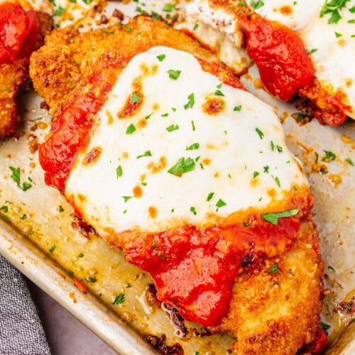 A piece of Gluten-Free Chicken Parmesan on a baking tray.