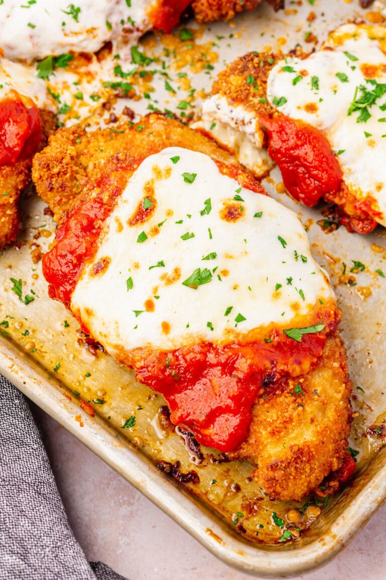A piece of Gluten-Free Chicken Parmesan on a baking tray.