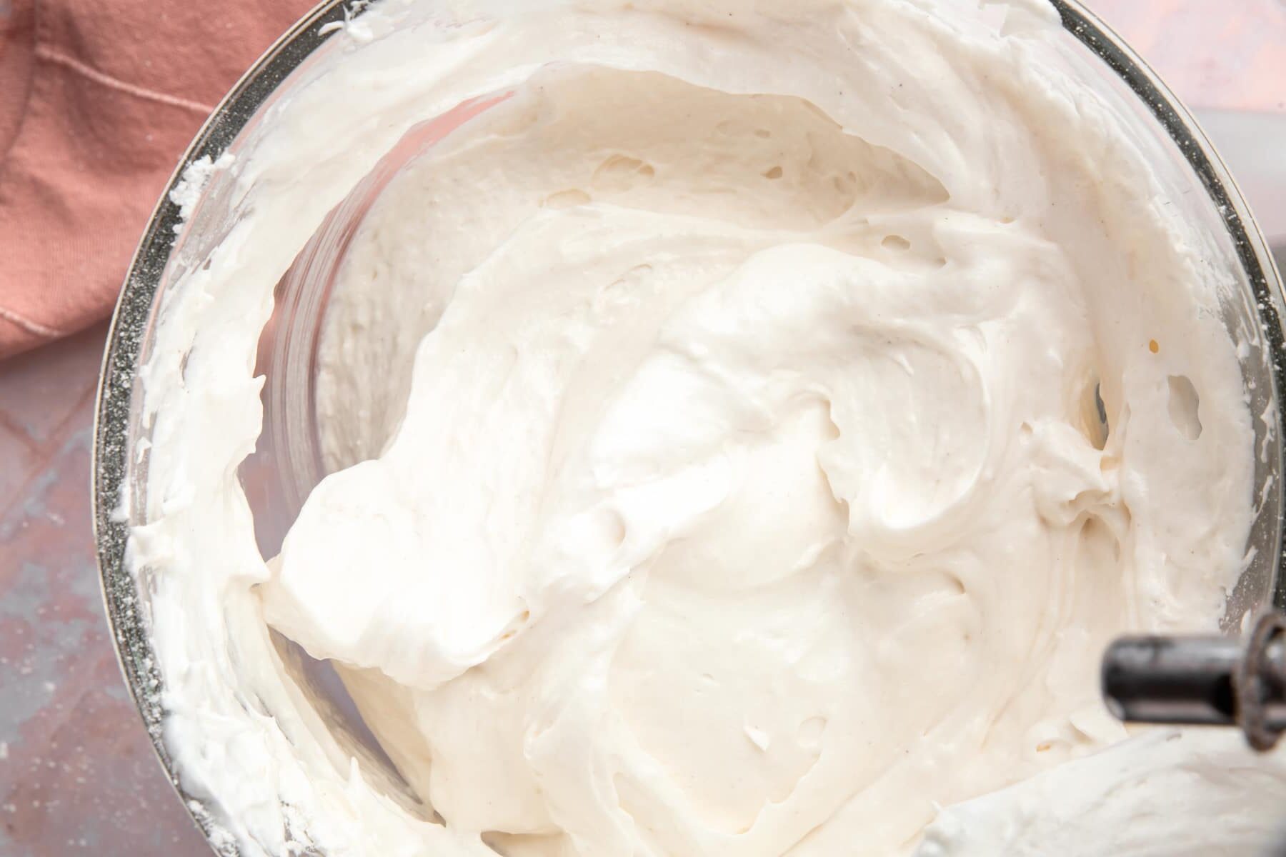 Raw angel food cake batter in a glass mixing bowl.