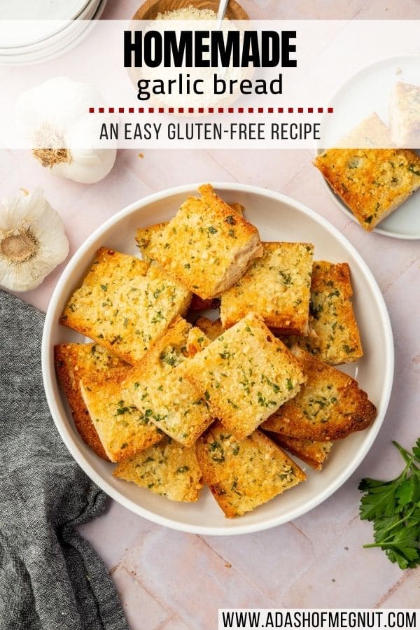 A bowl of gluten-free garlic bread slices on a pink herringbone table with a text overlay.