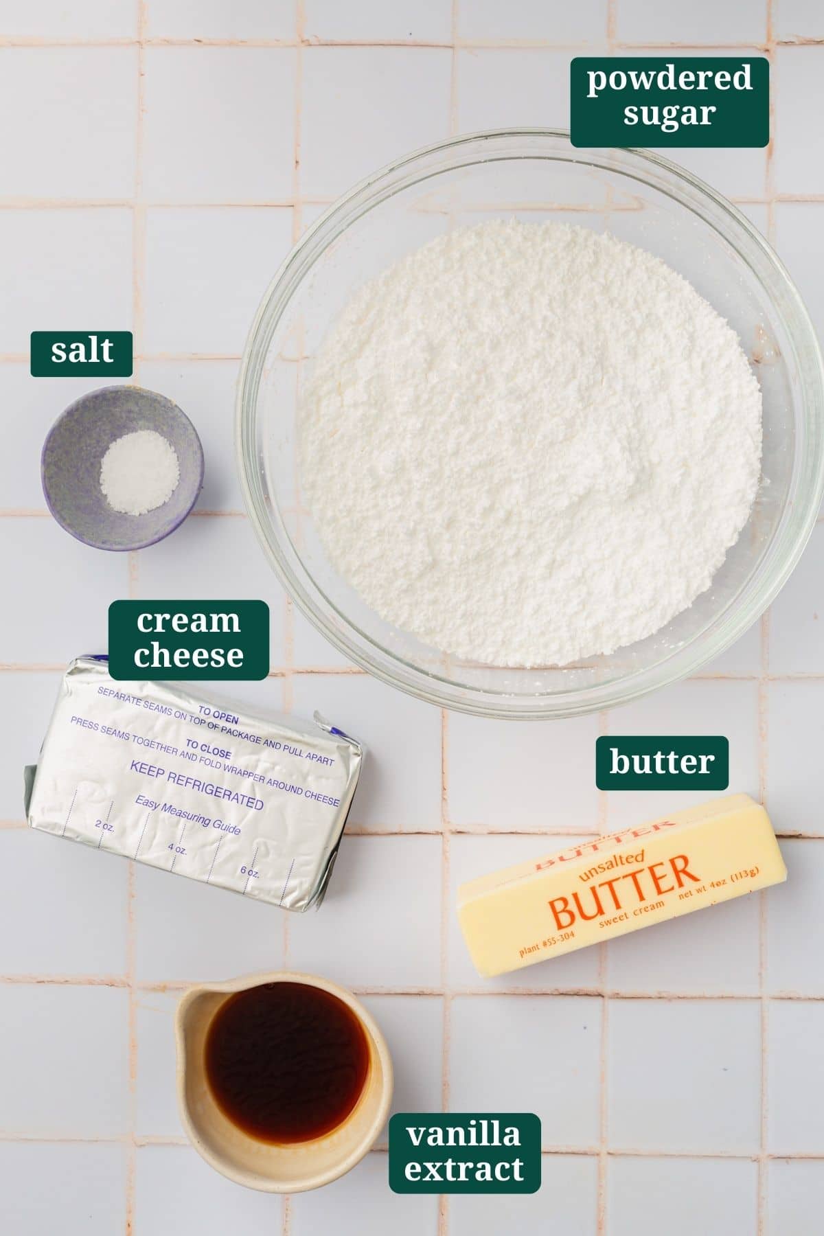 Ingredients to make brown butter cream cheese frosting on a tile counter. 