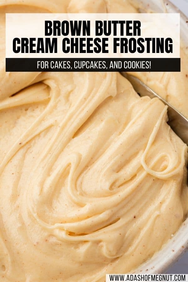 Brown butter cream cheese frosting swirled with a spatula in a bowl.