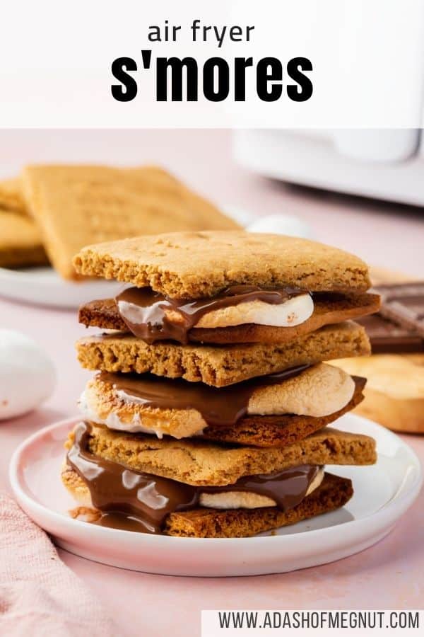 A stack of three s'mores on a plate with an air fryer in the background.
