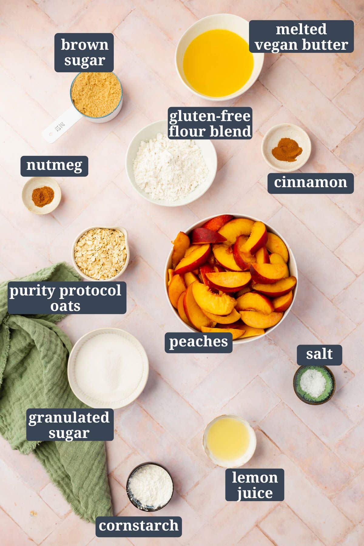 Ingredients mise en placed in small bowls to make gluten-free vegan peach crisp with text overlay on each bowl stating the ingredient.