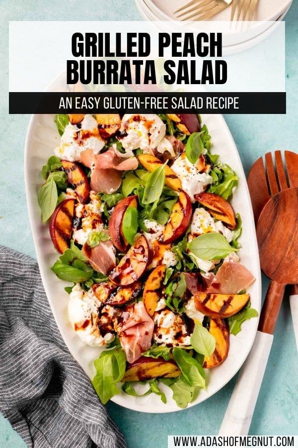 An oval plate with grilled peach salad with arugula, basil, burrata, prosciutto, balsamic vinegar glaze, and olive oil.