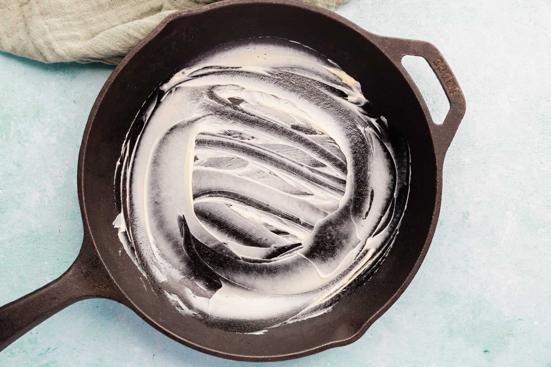 Butter smeared over a cast iron skillet.