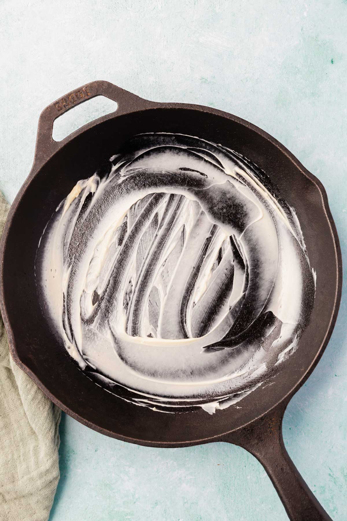Butter smeared over a cast iron skillet.