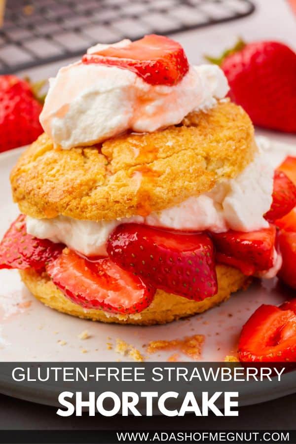 A gluten-free strawberry shortcake with fresh whipped cream and sliced strawberries on a dessert plate.