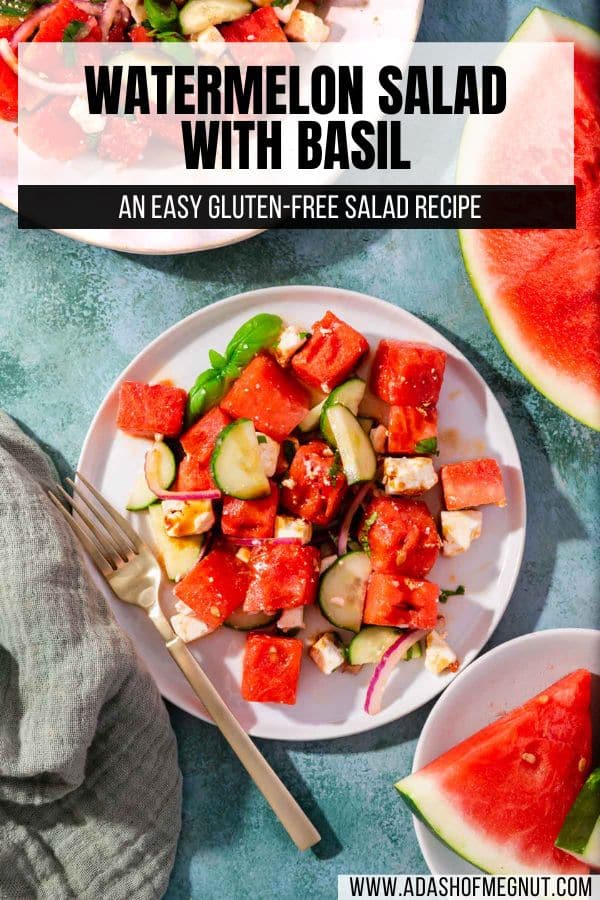 A salad plate with watermelon cucumber basil salad on it with large pieces of watermelon on the side.