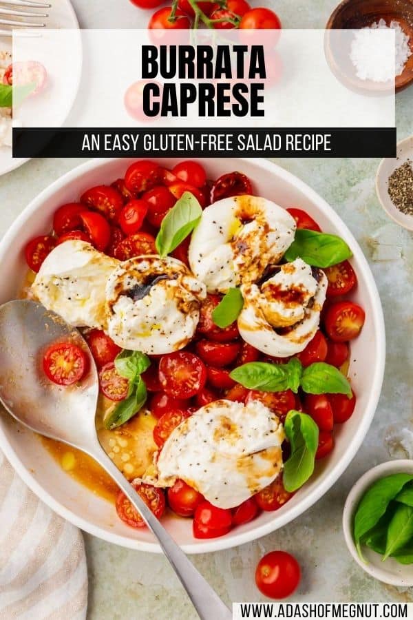 An overhead view of a shallow bowl of burrata cheese, sliced tomatoes, basil, and balsamic glaze.