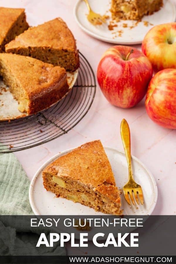 A slice of apple cake on a dessert plate with a fork with more slices of cake and apples in the background.