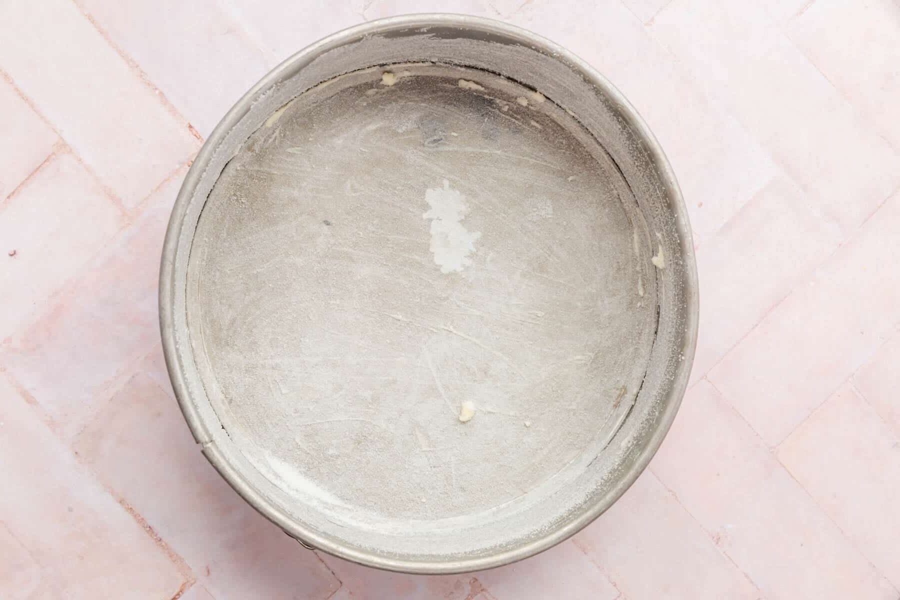 A springform pan greased with butter and dusted with granulated sugar.