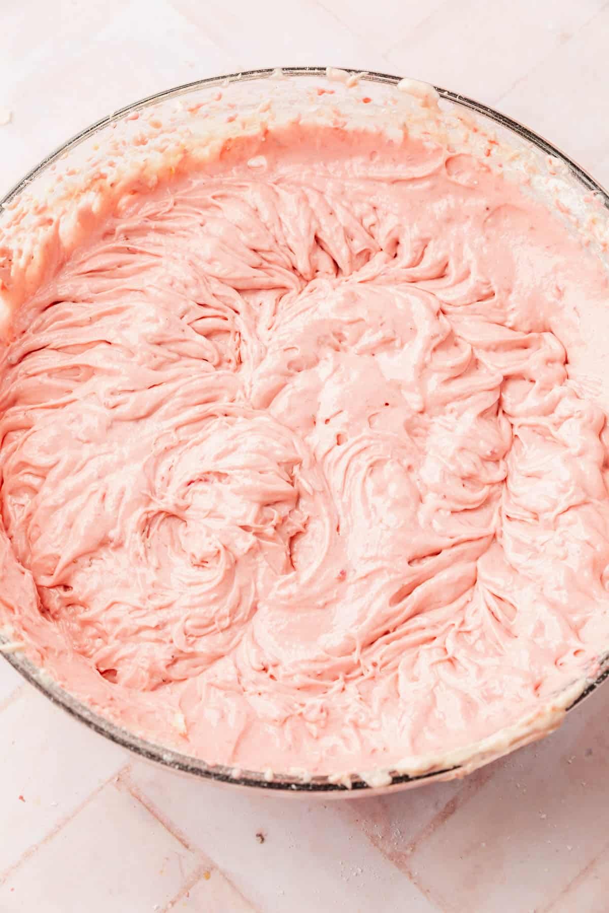 A large mixing bowl with gluten-free strawberry cake batter in it.