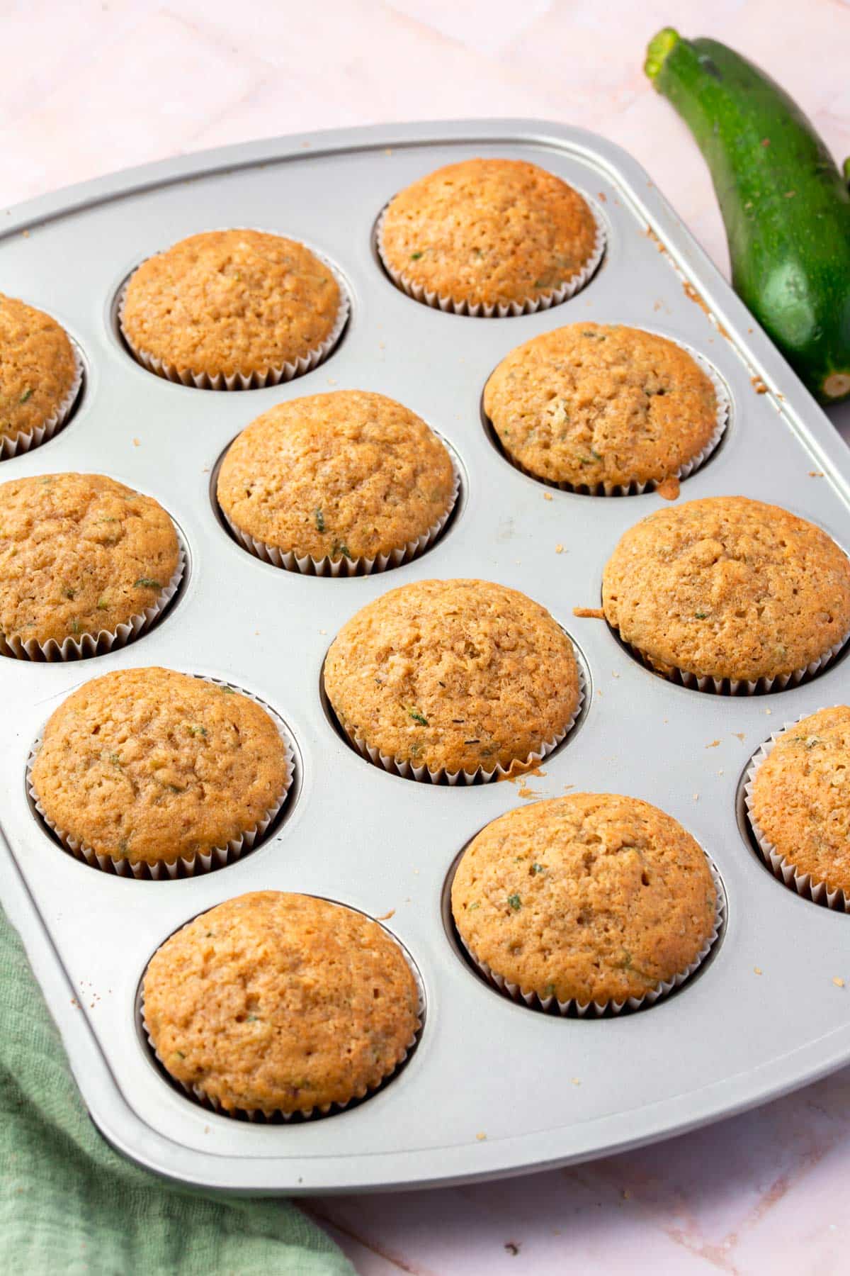 Gluten-free zucchini muffins in a muffin tin.