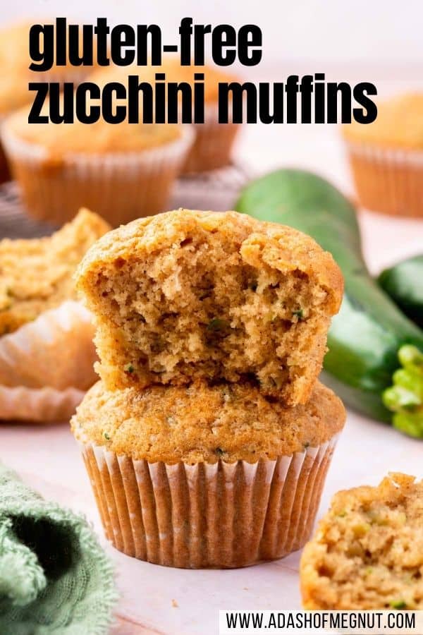 A stack of two gluten-free zucchini muffins with the top one having a bite taken out of it.